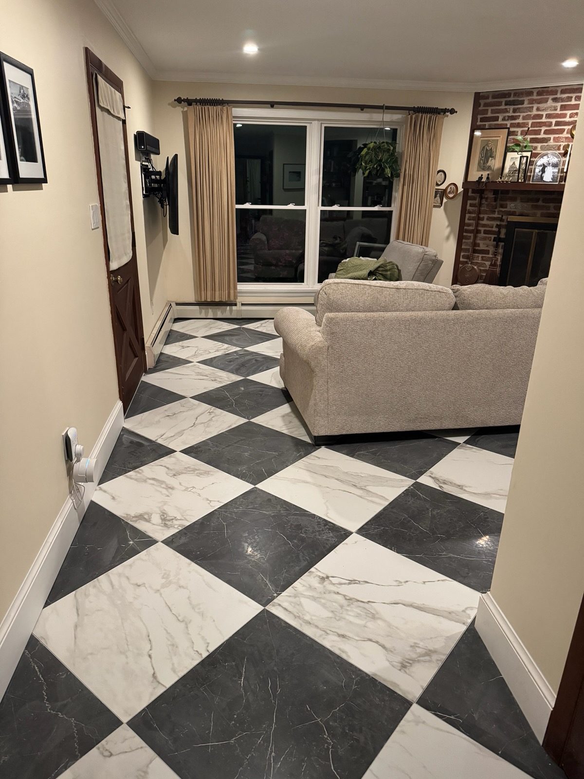 Living room after with a black and white marble look checkerboard tile floor