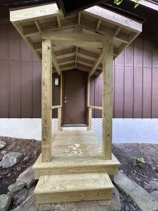 New covered entry porch with pressure treated posts, a gable roof and box steps