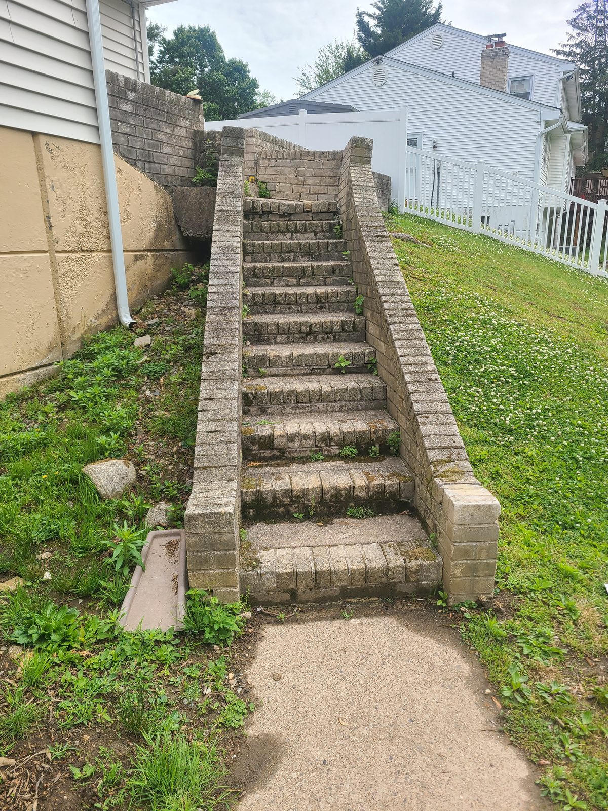 Front view of the original block steps with cracked and settled treads