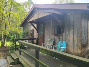 Entry deck and ramp before the exterior was redone, with weathered siding and an old wood railing